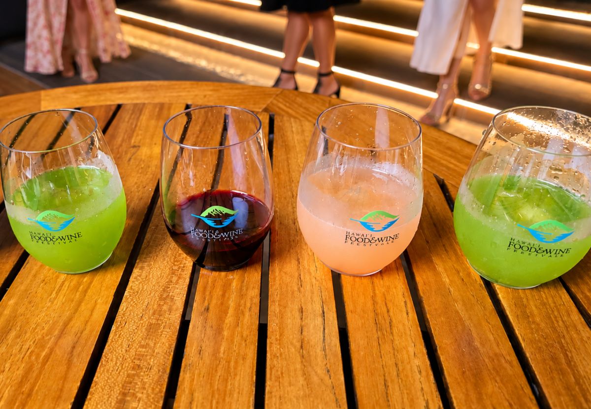 Four festival glasses on a table between the stations