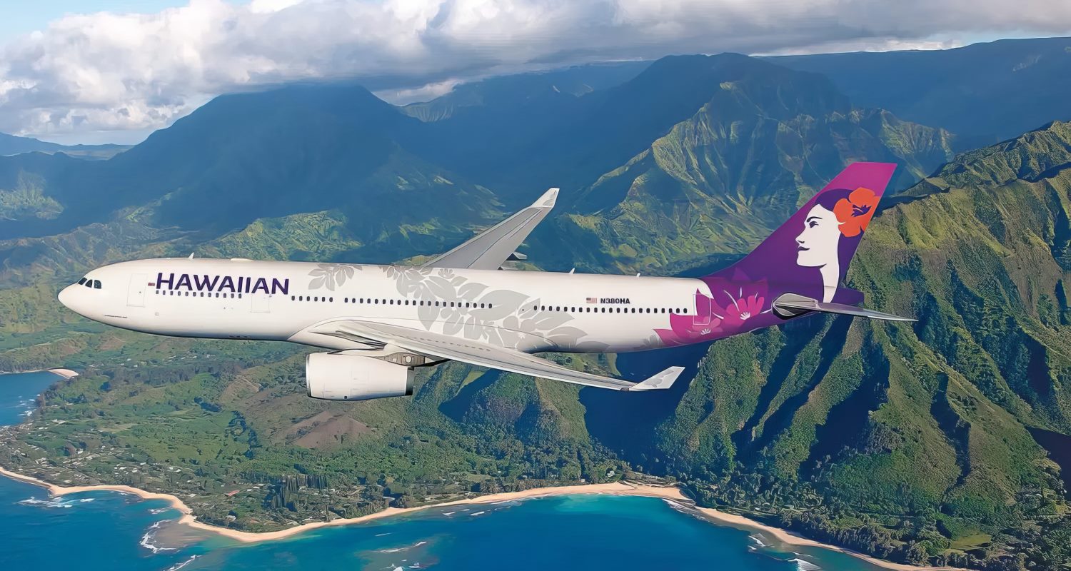 Hawaiian Airlines aircraft flying along the Hawaii coastline