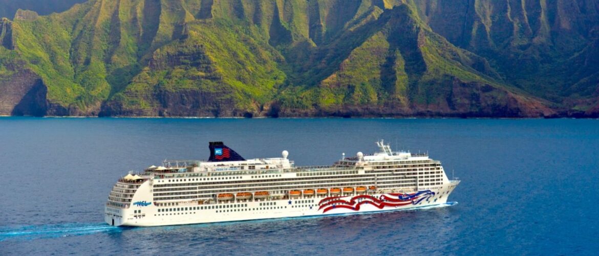NCL Pride of America cruising past the green cliffs of the Napali Coast on Kauai