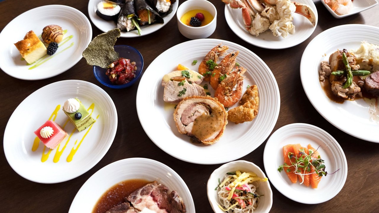 Plates from the Seafood and Prime Buffet at 100 Sails: snow crab, shrimp, sashimi, porchetta, prime rib and desserts