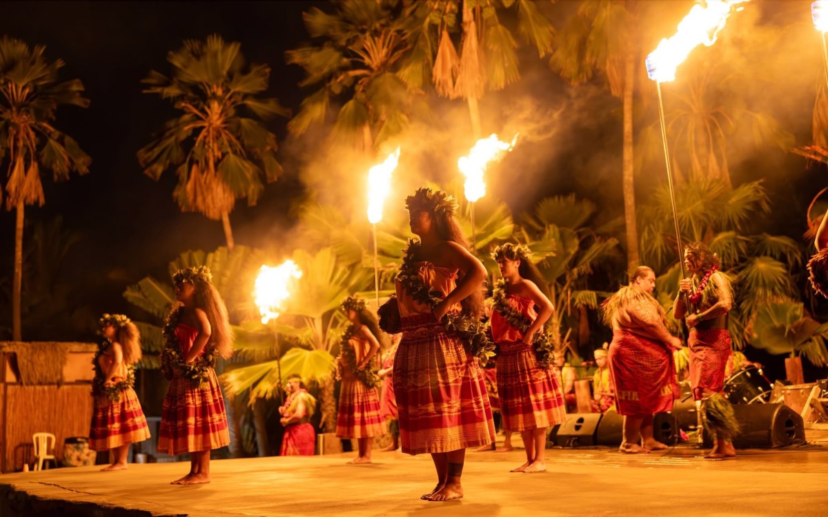 Fire knife dancers and the cast performing after dark at Chiefs Luau